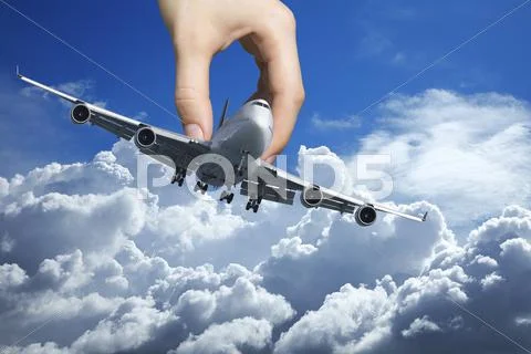 Hand playing with a real jet aircraft Stock Photos