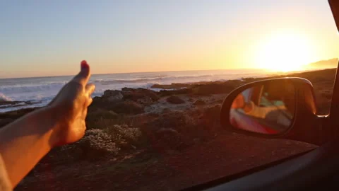 Hand Playing in the Wind Through Car Window on Road Trip Stock Footage 313157327