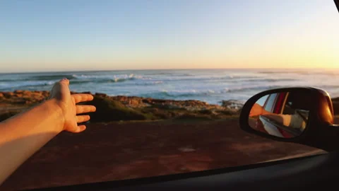 Hand Playing in the Wind Through Car Window on Road Trip Stock Footage 313157617