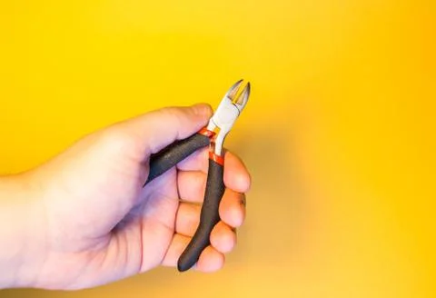 Hand with pliers Stock Photos