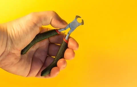 Hand with pliers Stock Photos