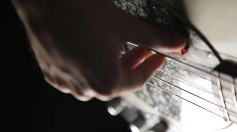 Hand plucked the strings on a guitar Stock Footage 41720042