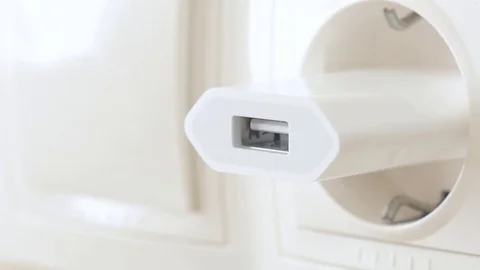 Hand plug usb charger adapter and wire into wall socket. Stock Footage 80593529