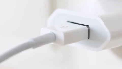 Hand plug usb charger adapter and wire into wall socket. Stock-Footage 80593535