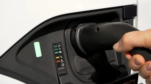 Hand plugging and unplugging the charger of an  electric vehicle Stock Footage 105679397