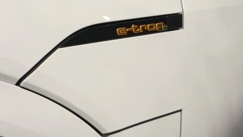 Hand plugging and unplugging the charger of an Audi e-tron electric vehicle Stock Footage 105679751