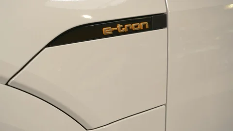 Hand plugging and unplugging the charger of an Audi e-tron electric vehicle Stock Footage 105679989