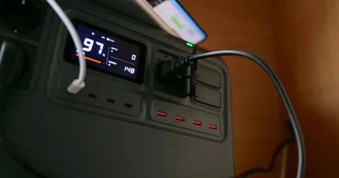 Hand Plugging Black Power Cord Into Portable Power Station With Digital Display Stock Footage 322208332