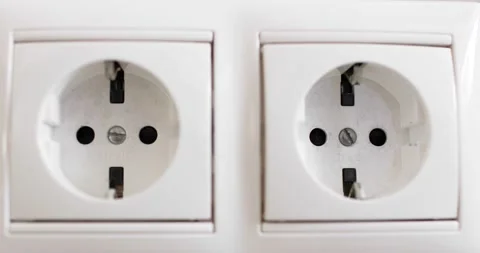 Hand plugging black power plug into white multiple socket indoors. Stock Footage 156792438
