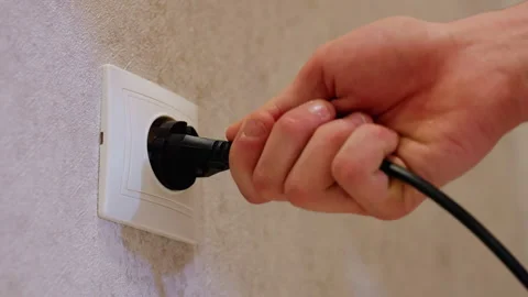 Hand Plugging Black Wire Into Wall Socket Close Up Stock Footage 319919107