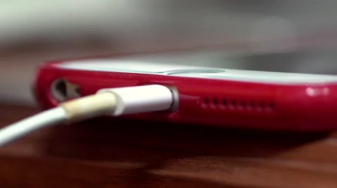 Hand plugging the charger into cell phone 스톡 동영상 64729946