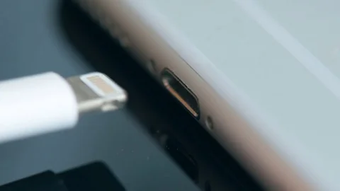 Hand plugging the charger into cell phone. Stock Footage