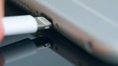 Hand plugging the charger into cell phone. Stock Footage 80593562