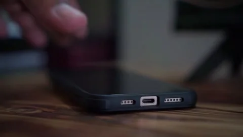 Hand plugging charging cable into smartphone, charging phone battery, technology Stock Footage 344432161