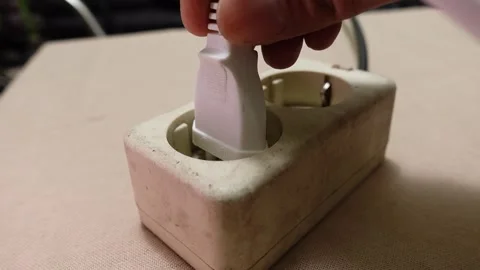 A Hand Plugging an Electrical Plug into a Household Socket Video stock 307437212