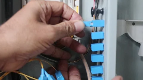 Hand plugging fiber optic cable connector into terminal device Video stock 289269534