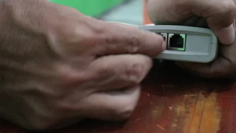 Hand plugging a local network cable Stock Footage 306568302