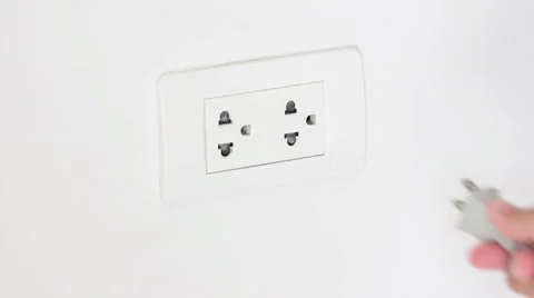 A Hand Plugging In A Power Cord And Then Unplugging Video stock 65816872
