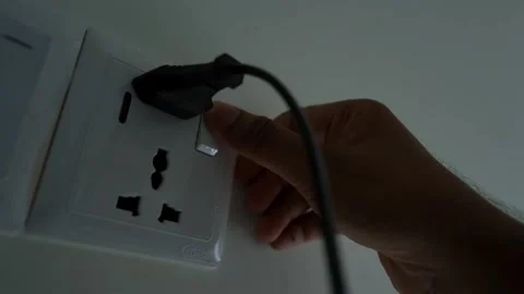 Hand Plugging Power Cord into Wall Socket Stock Footage 317737246