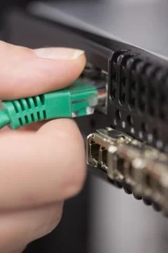 Hand plugging in USB Stock Photos