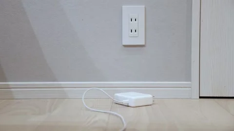 Hand plugging white power strip into Japanese wall outlet at home lifestyle Stock Footage 333238417
