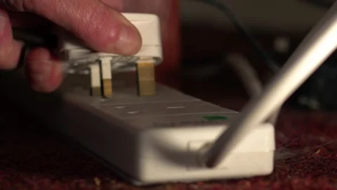 Hand plugs into electric socket Stock Footage 277591225