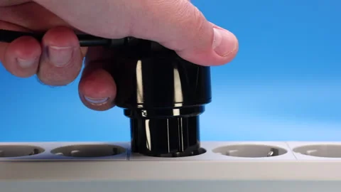 Hand Plugs The Plug With Adapter Into An Extension Cord Socket. 4k, 60 FPS, ProR Stock Footage 244993456
