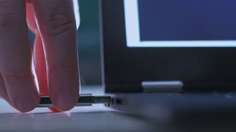 Hand plugs in USB flash drive into a laptop computer Stock Footage 143006964