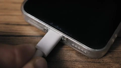 Hand Plugs White USB-C Cable Into Smartphone Port Macro Stock Footage 319740009