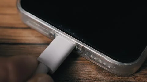 Hand Plugs White USB-C Cable into Smartphone Port Stock Footage 320889314