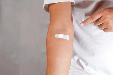 Hand pointing to arm with injection marks Stock Photos