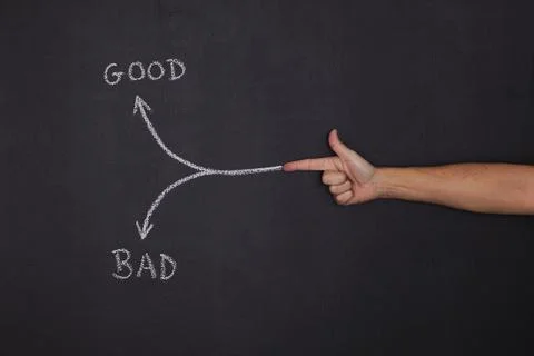 Hand pointing to a arrow that point to good or bad decisions Stock Photos