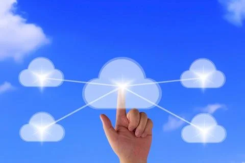 Hand pointing to cloud computing network icon on blue sky background Stock Photos