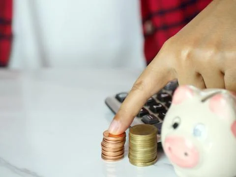 Hand pointing at coins on table. Saving money and financial business concep.. Stock Photos