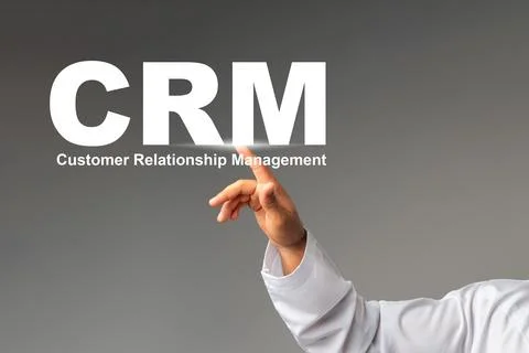 Hand pointing to CRM letters representing customer relationship management Stock Photos