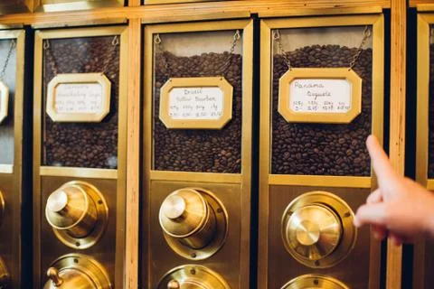 Hand pointing at different coffee beans in a shop Foto stock