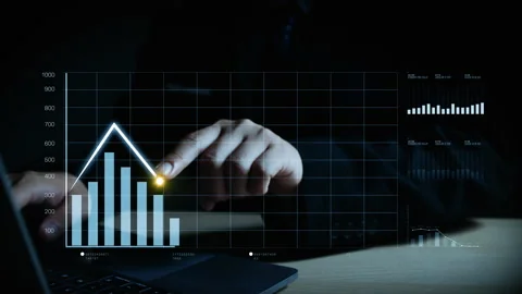 Hand pointing at digital chart with rising bars and trend lines, symbolizin. Stock Footage 325685238