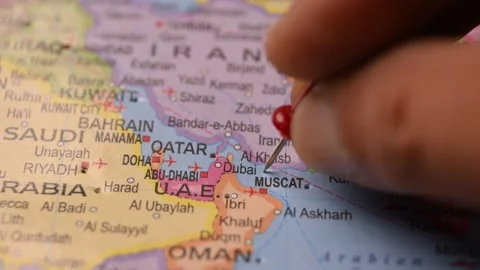 Hand Pointing Dubai UAE with Red Pin on World Map 4K 60fps Stock Footage 333571021