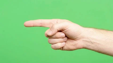 Hand pointing finger on bright green background Stock Photos