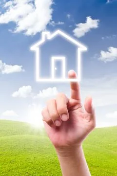Hand pointing to house icon Stock Photos