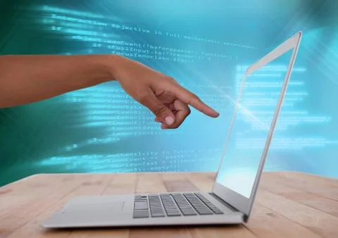 Hand pointing at laptop with coding text Foto stock
