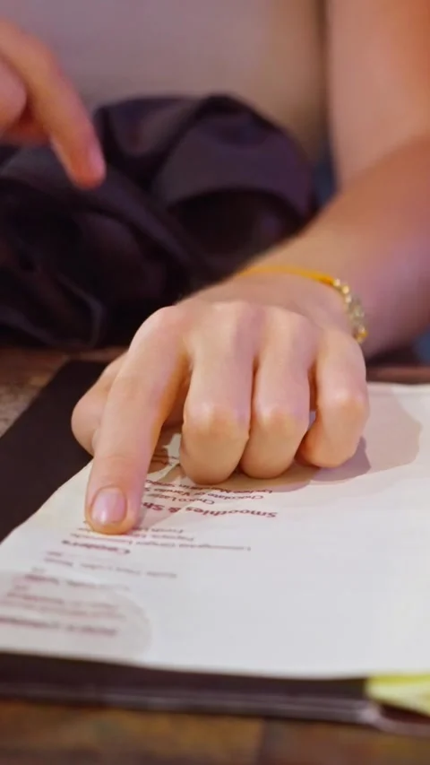 Hand Pointing at Menu in a Caf Setting Stock Footage 308111025