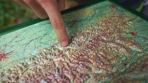 Hand pointing mountainous region on the map Stock Footage 77811477