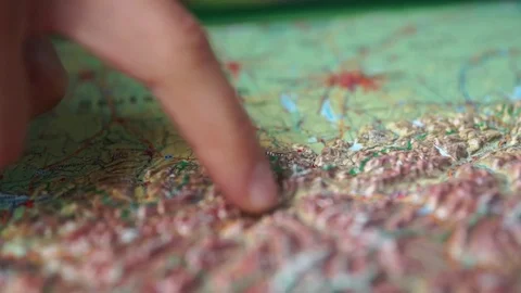 Hand pointing mountainous region on the map Stock Footage 77811485