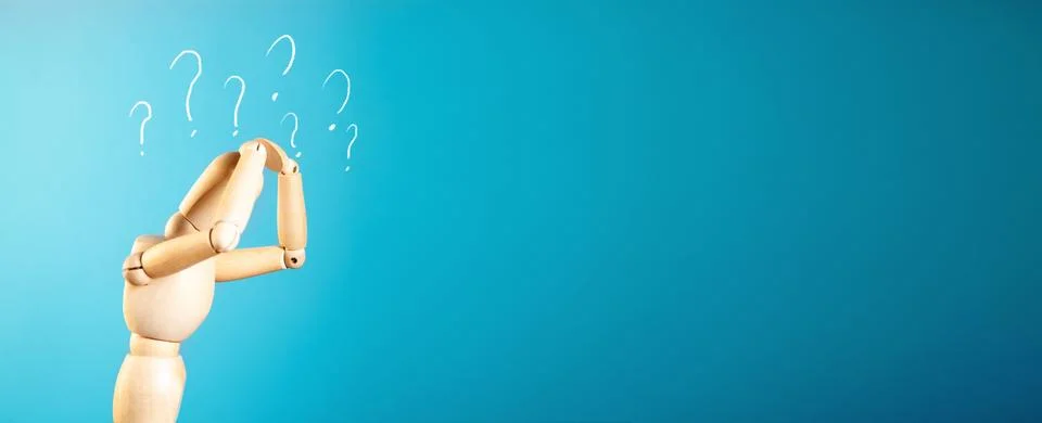 Hand pointing to the question mark on blue background. Stock Photos