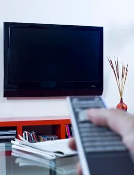 Hand Pointing A Remote Control To A TV Set Stock Photos