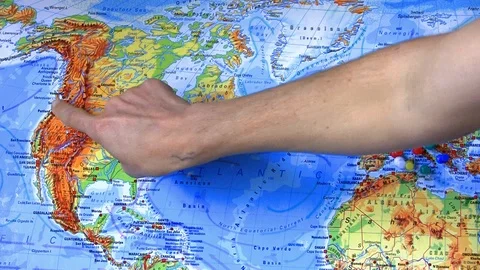 Hand pointing trip on a geographical map from America to Italy Video stock 104136913