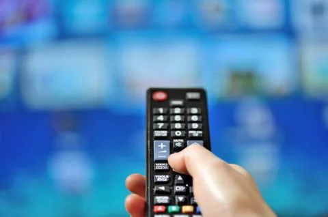 Hand pointing tv remote control Stock Photos