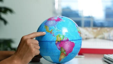 Hand pointing at world globe, Close-up of a hand pointing at north america .. Stock Footage 346484126
