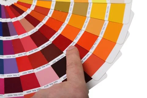 The hand points to a collection of ral colors isolated on a white background Stock Photos